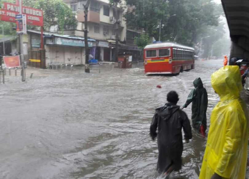 A bus struggles through a water-logged street after rains lashed Mumbai. All the means of transport are going down. Buses will perhaps support for sometime because cars and bikes can't move in most of the city.